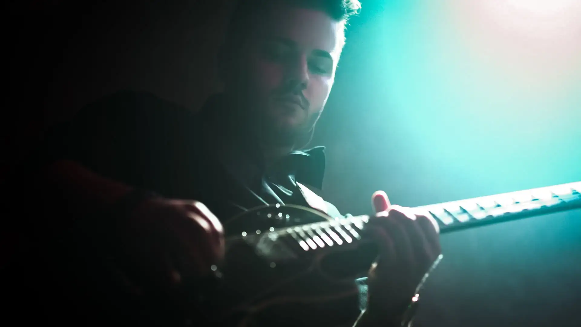 Maciej Mięso gra na gitarze podczas występu akustycznego